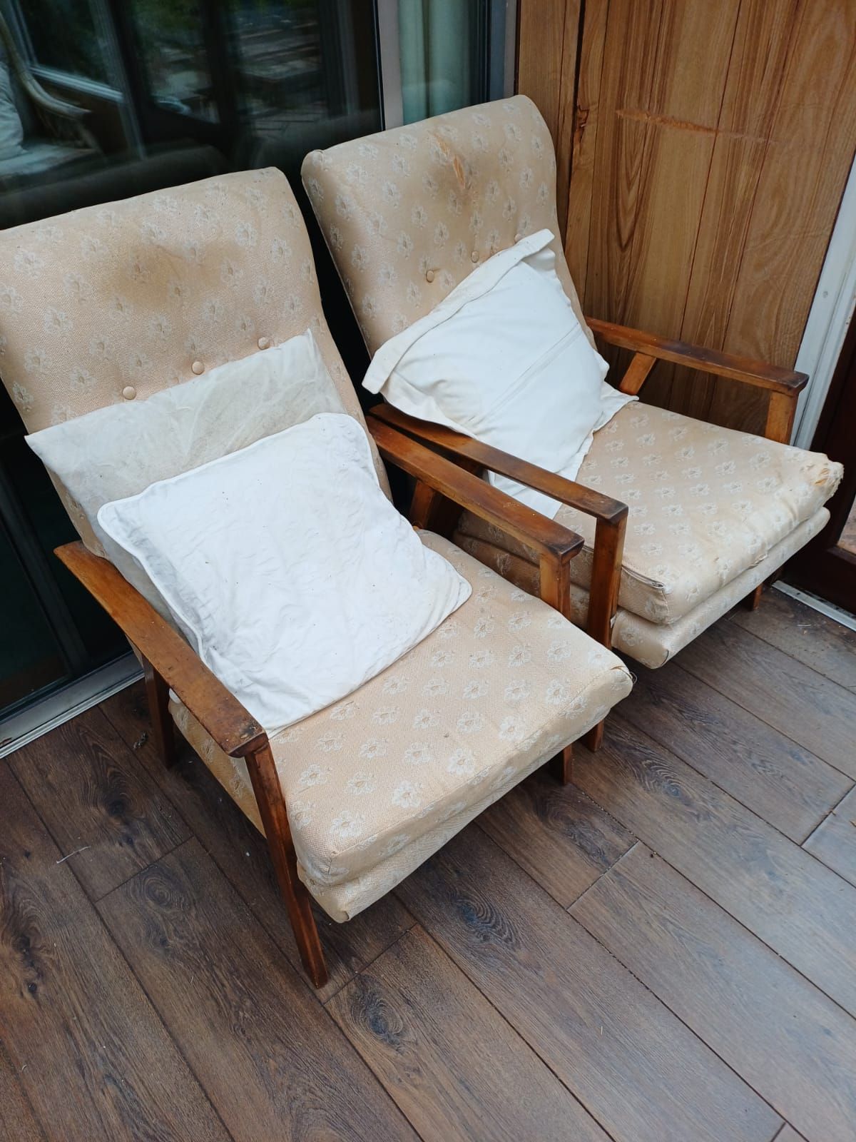 A pair of upholstered armchairs in good condition, set aside for reuse