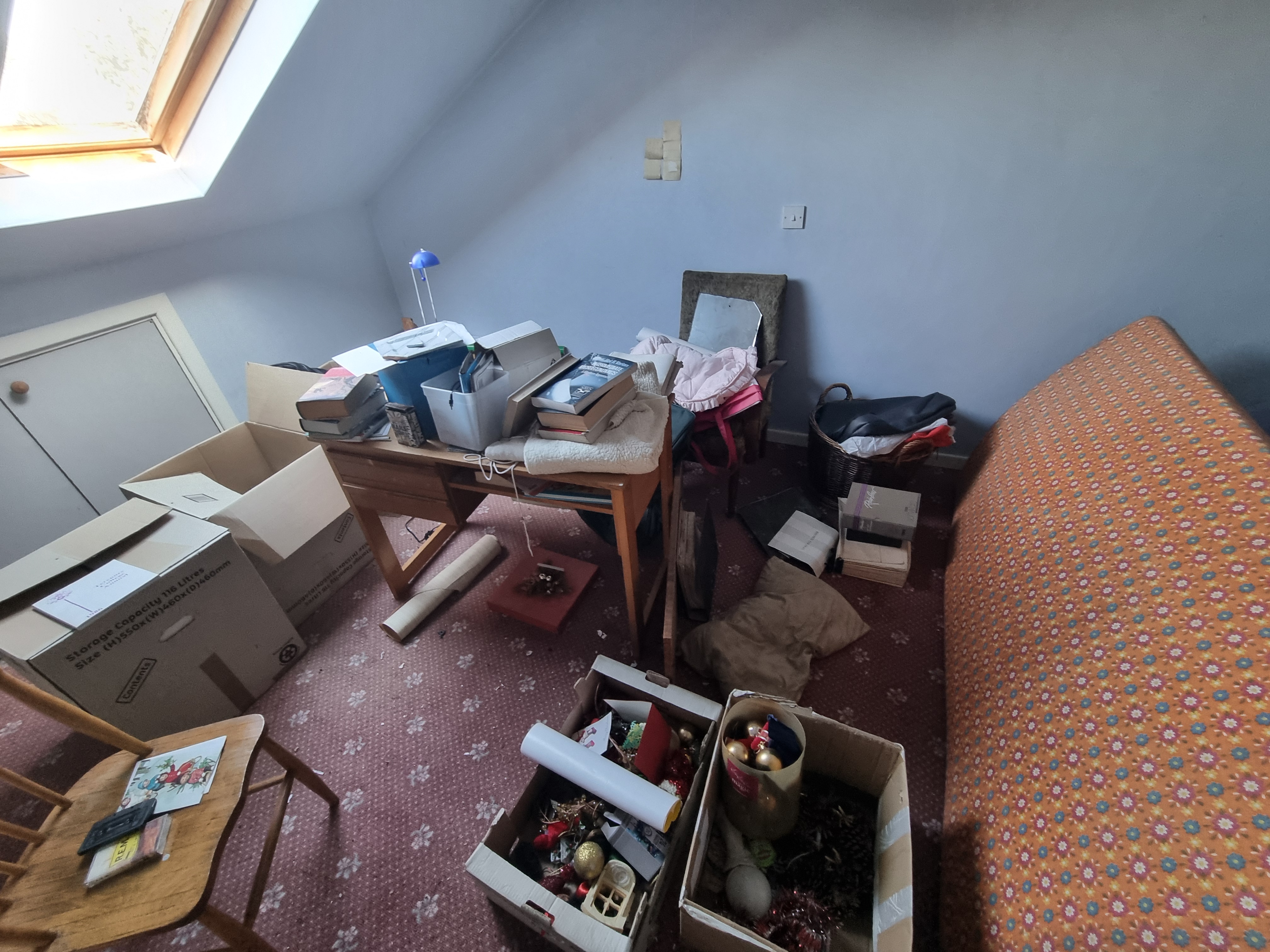 An attic room full of boxes ready for clearance