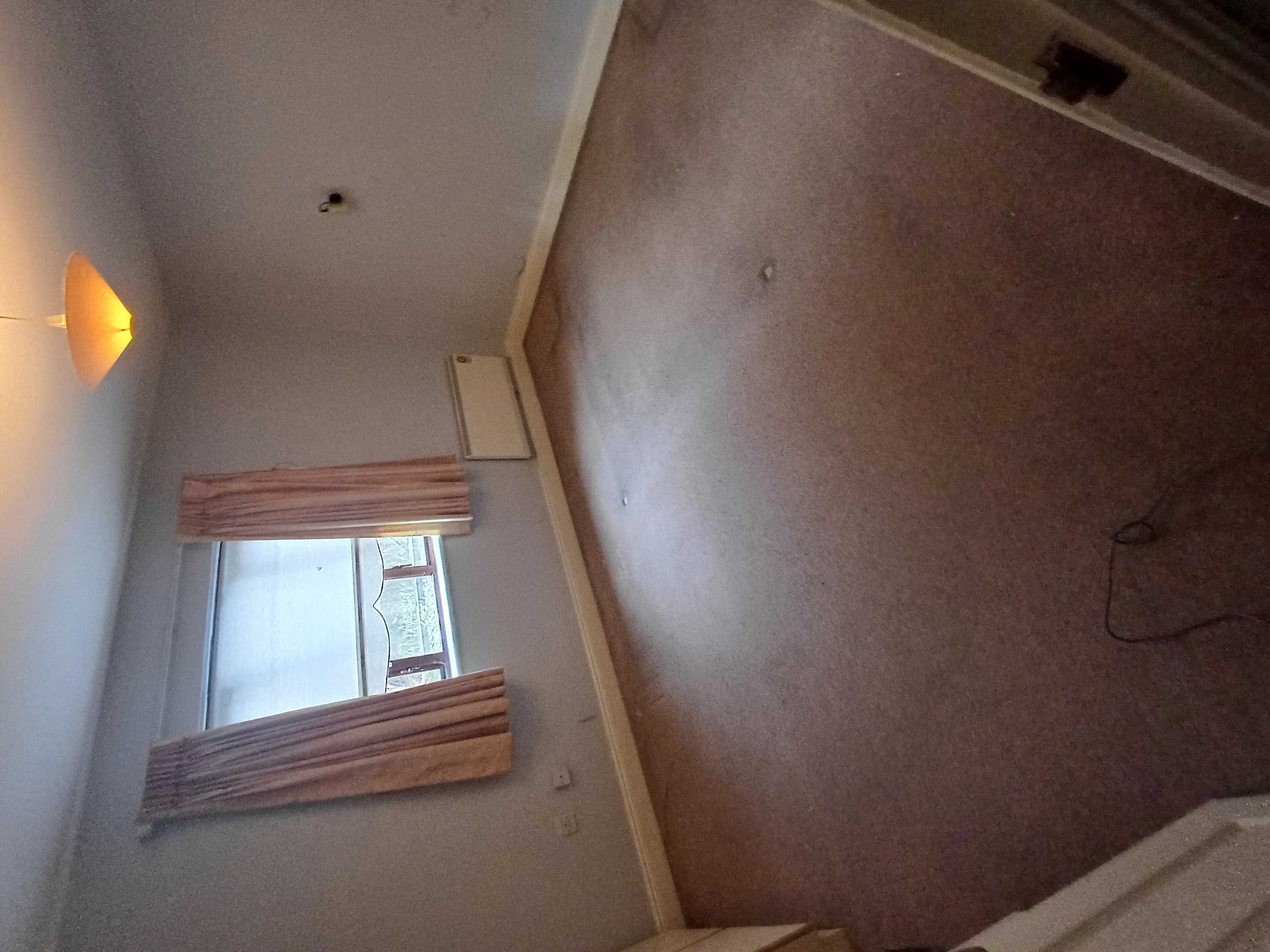 A bedroom left empty and cleared after a clearance