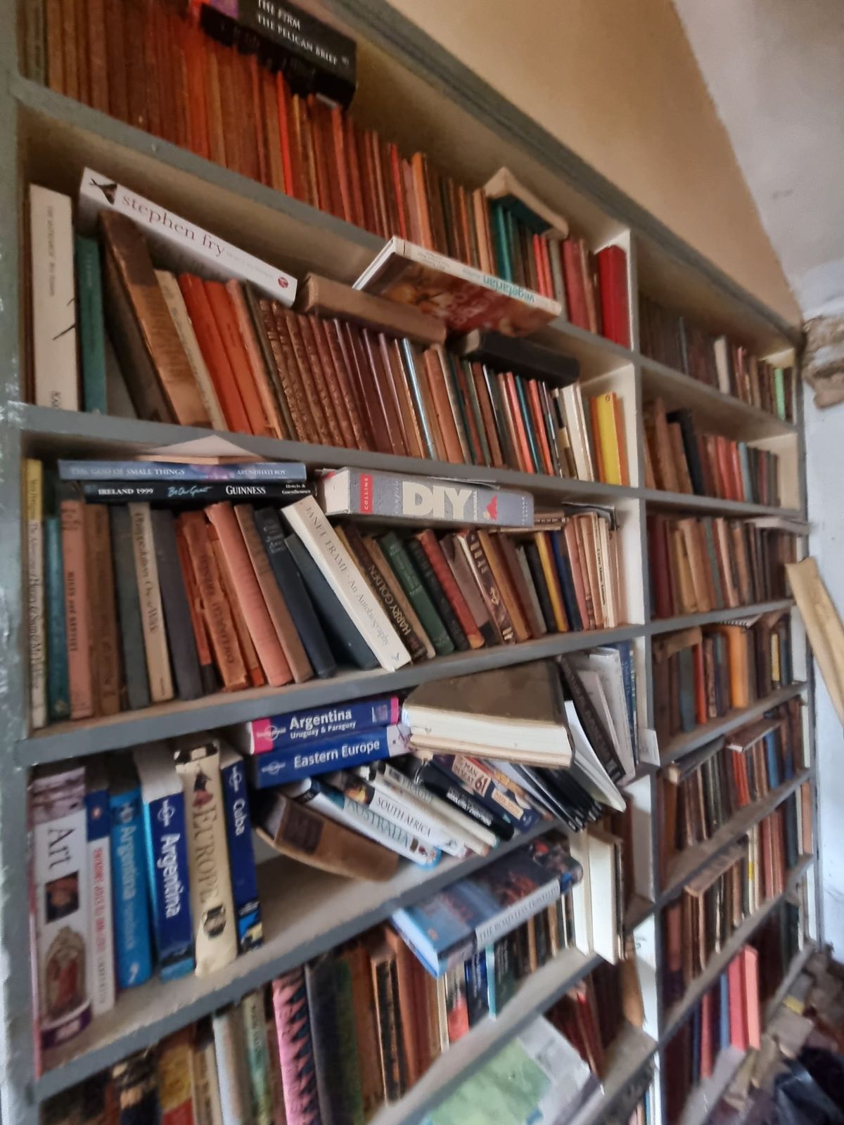 Shelves full of books in a family home before a clearance