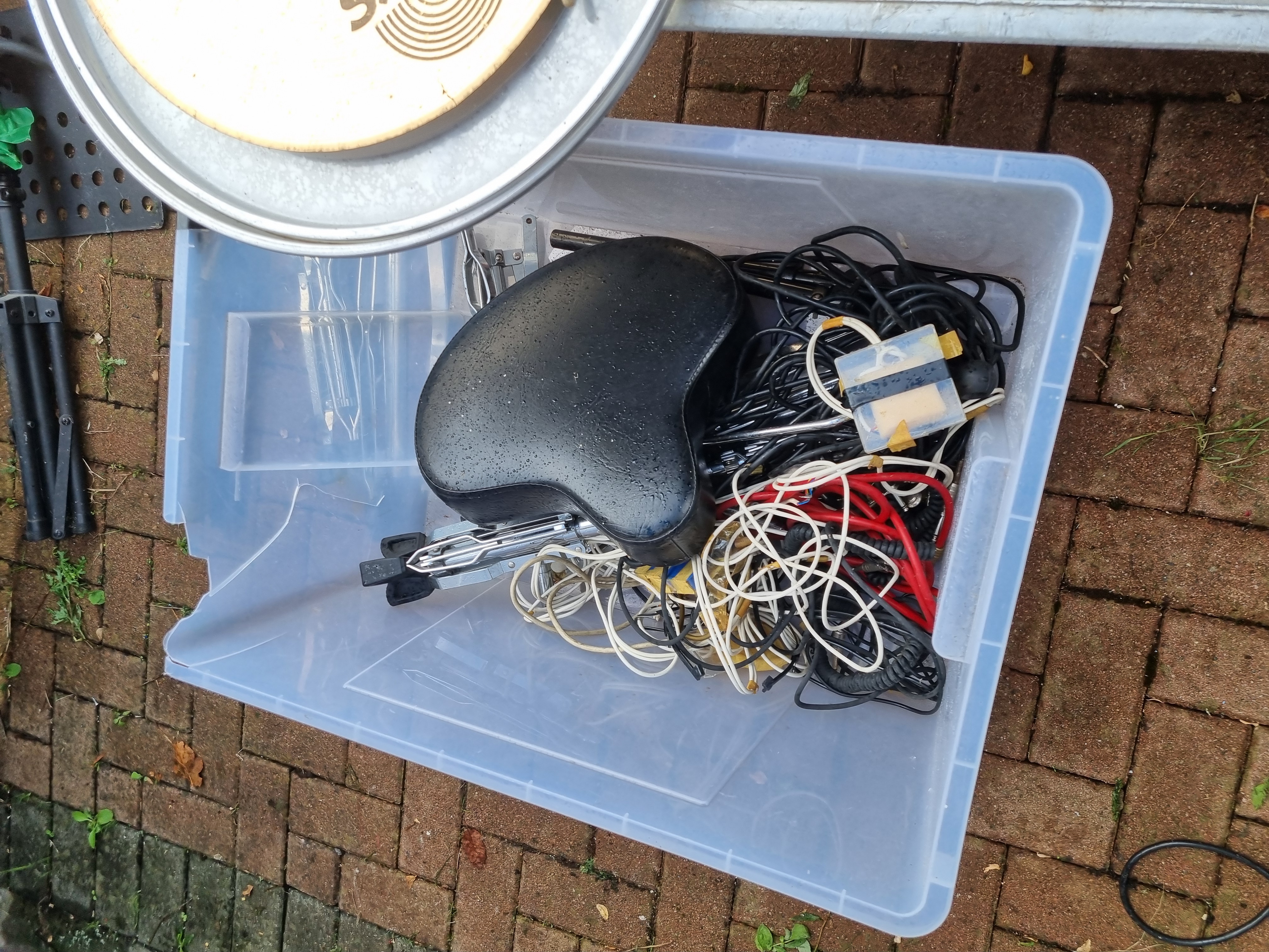 A storage bin of cables and tools cleared from a garage