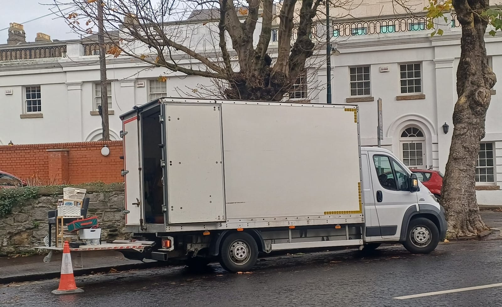 The HouseClearances.ie van with its tail lift down, loading furniture during a clearance in Dublin