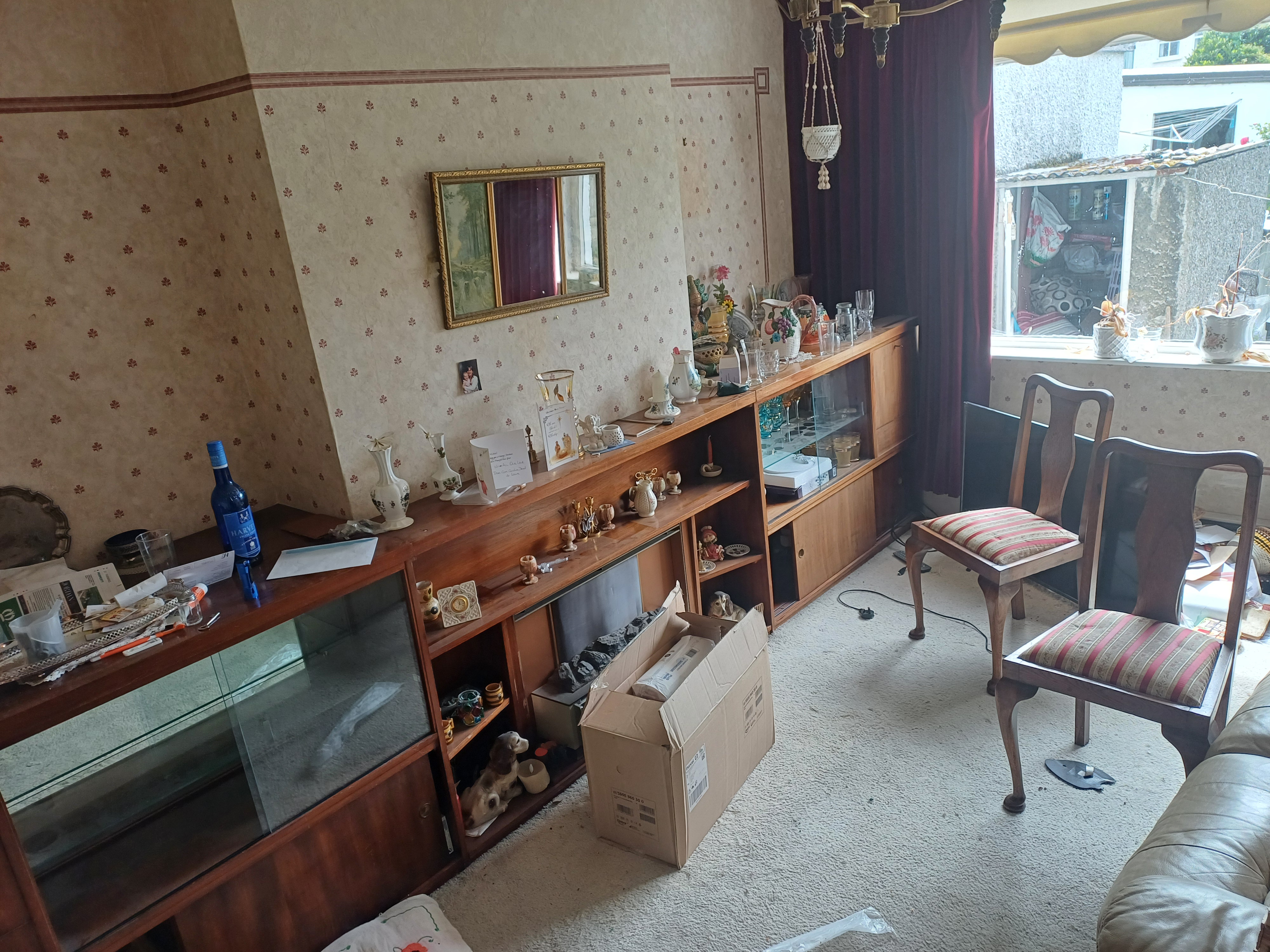 A living room display cabinet cleared during a house clearance