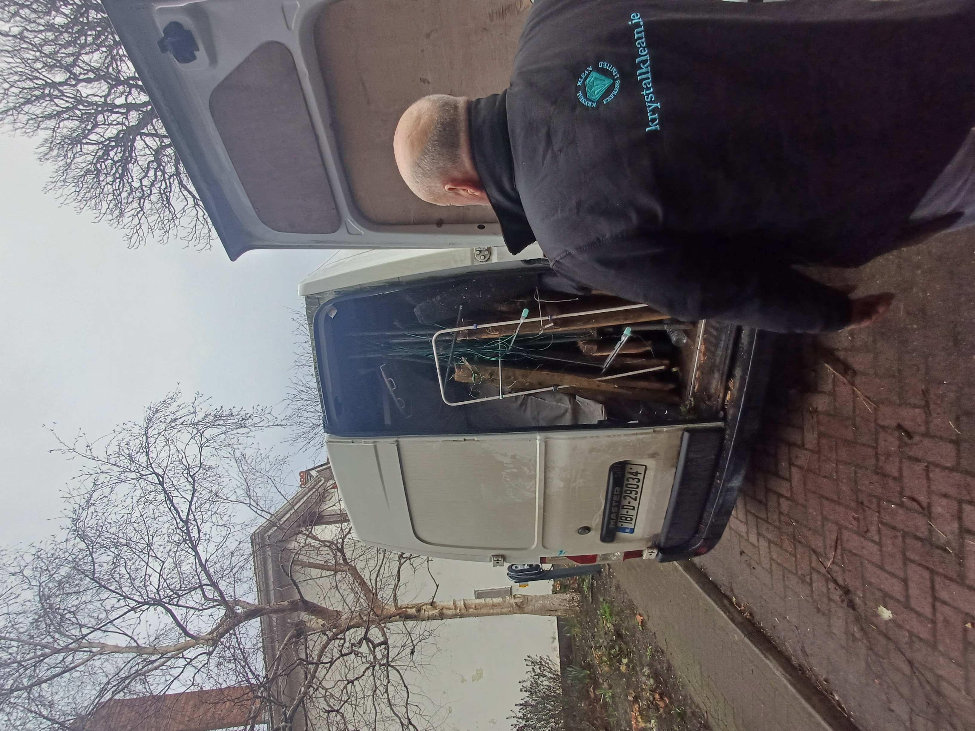 Clearance team loading furniture and boxes into a branded HouseClearances.ie van outside a property